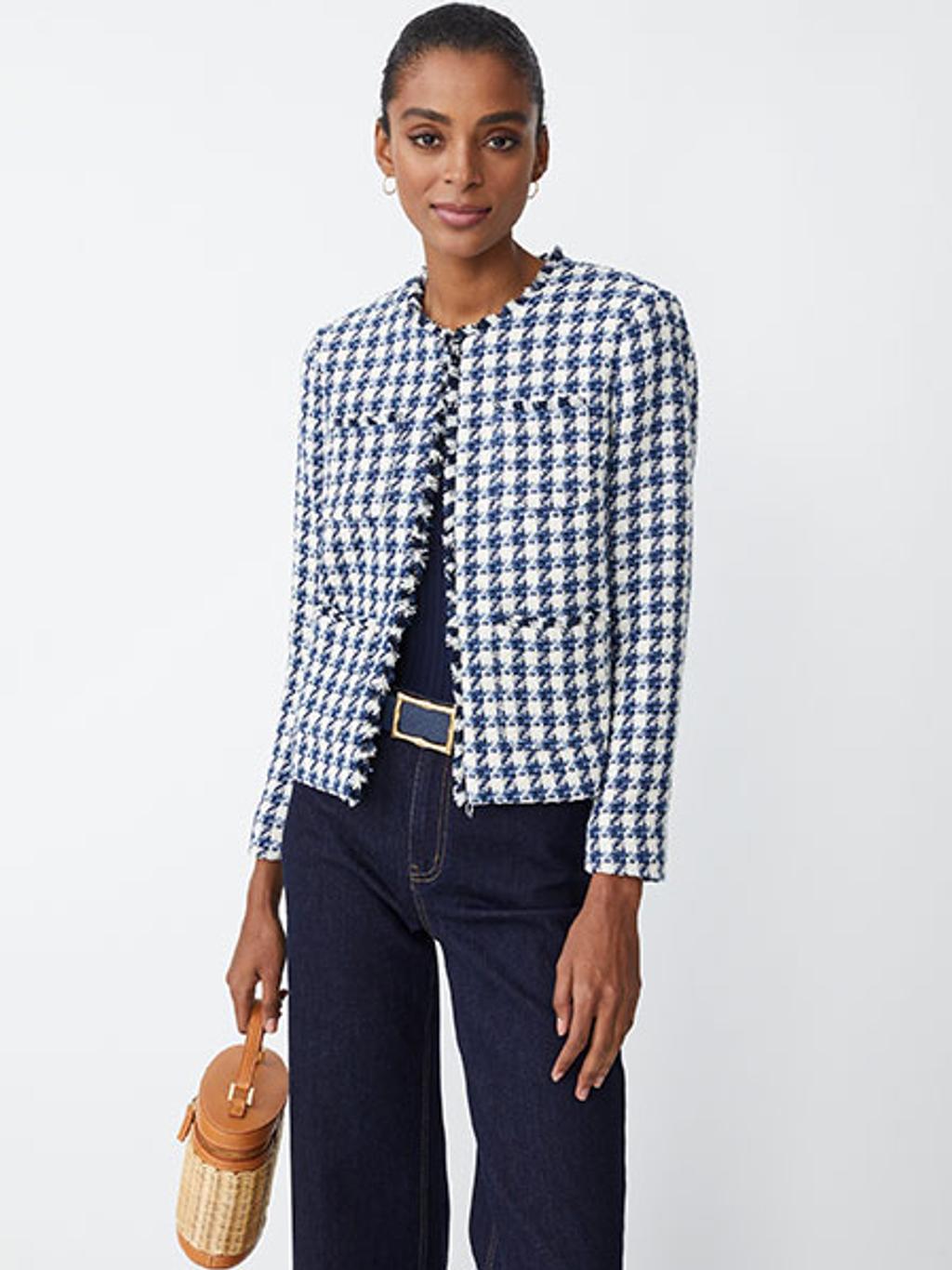 Model wearing tweed jacket and jeans with a bucket bag Model wearing tweed jacket and jeans with a bucket bag