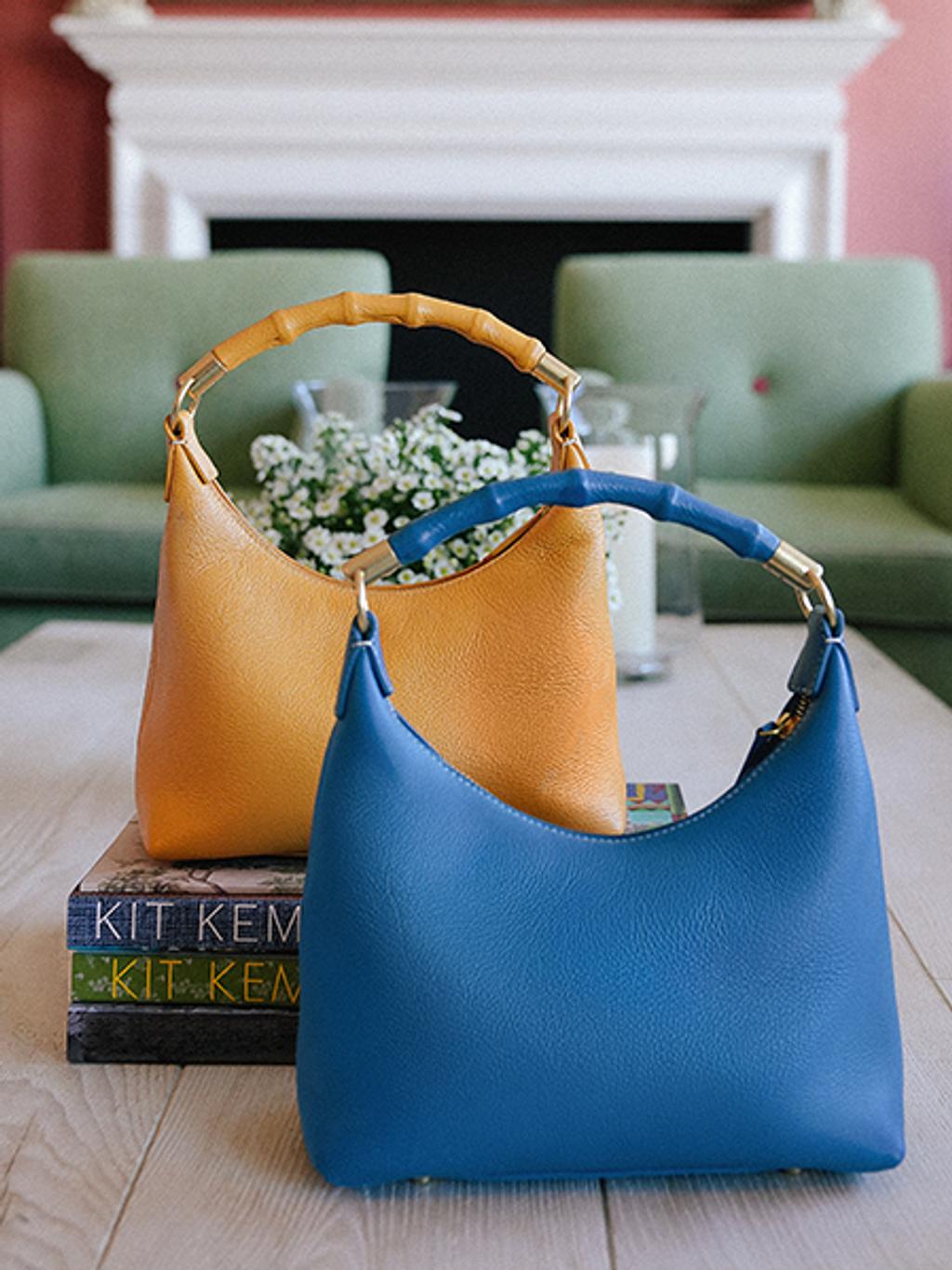 Bamboo handled leather bags in denim and golden yellow.