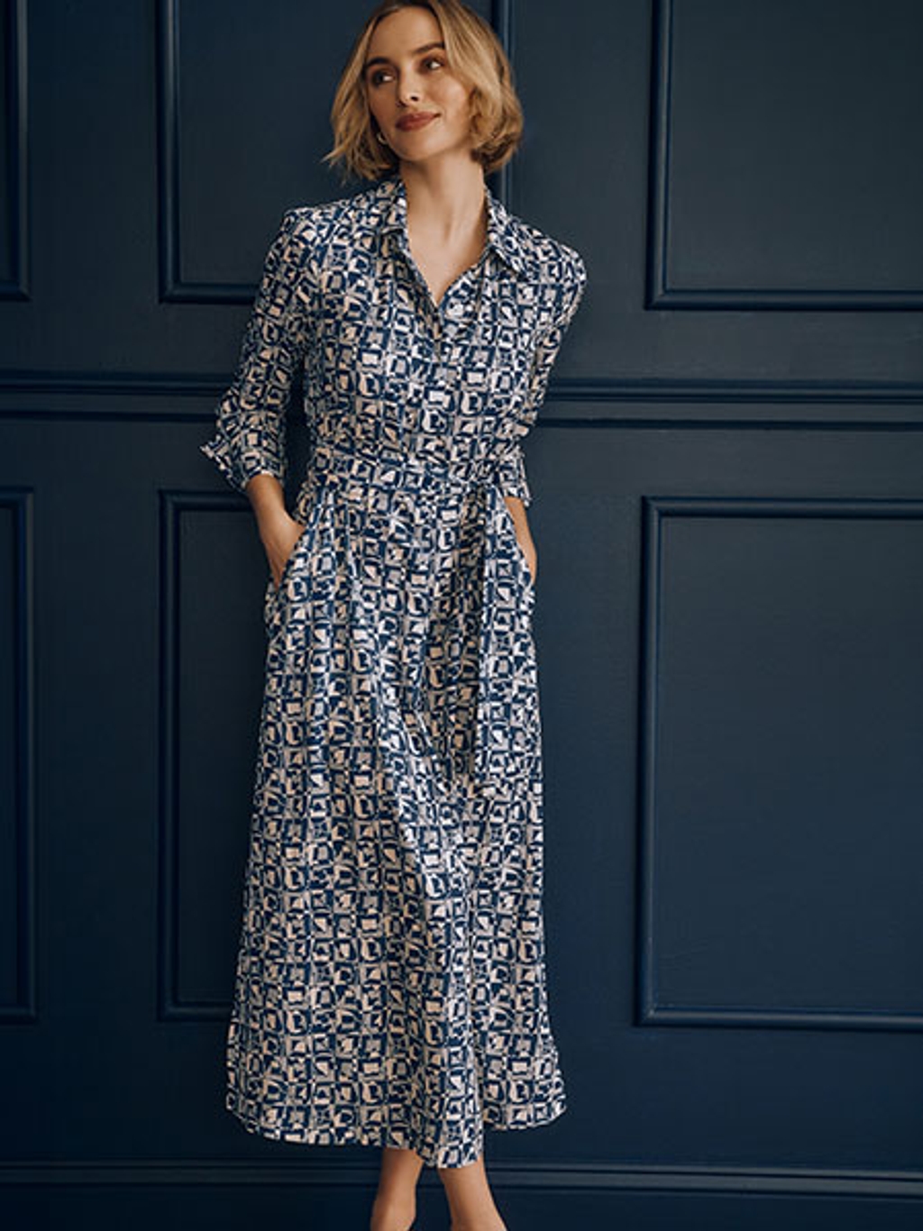 Model in navy and white patterned long sleeve dress