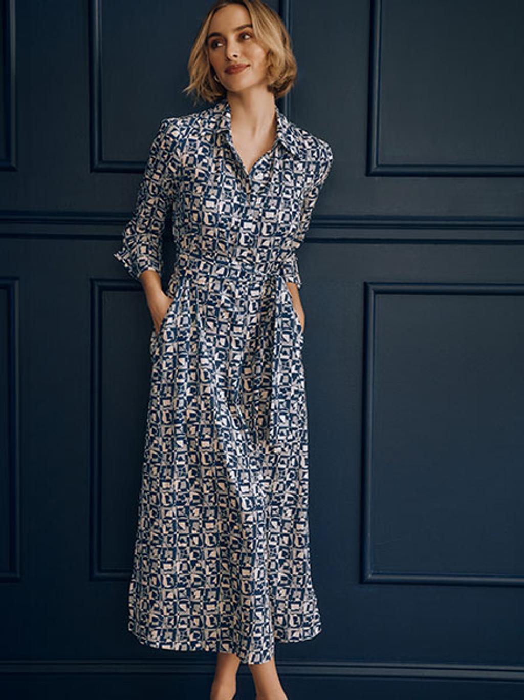 Model in navy and white patterned long sleeve dress