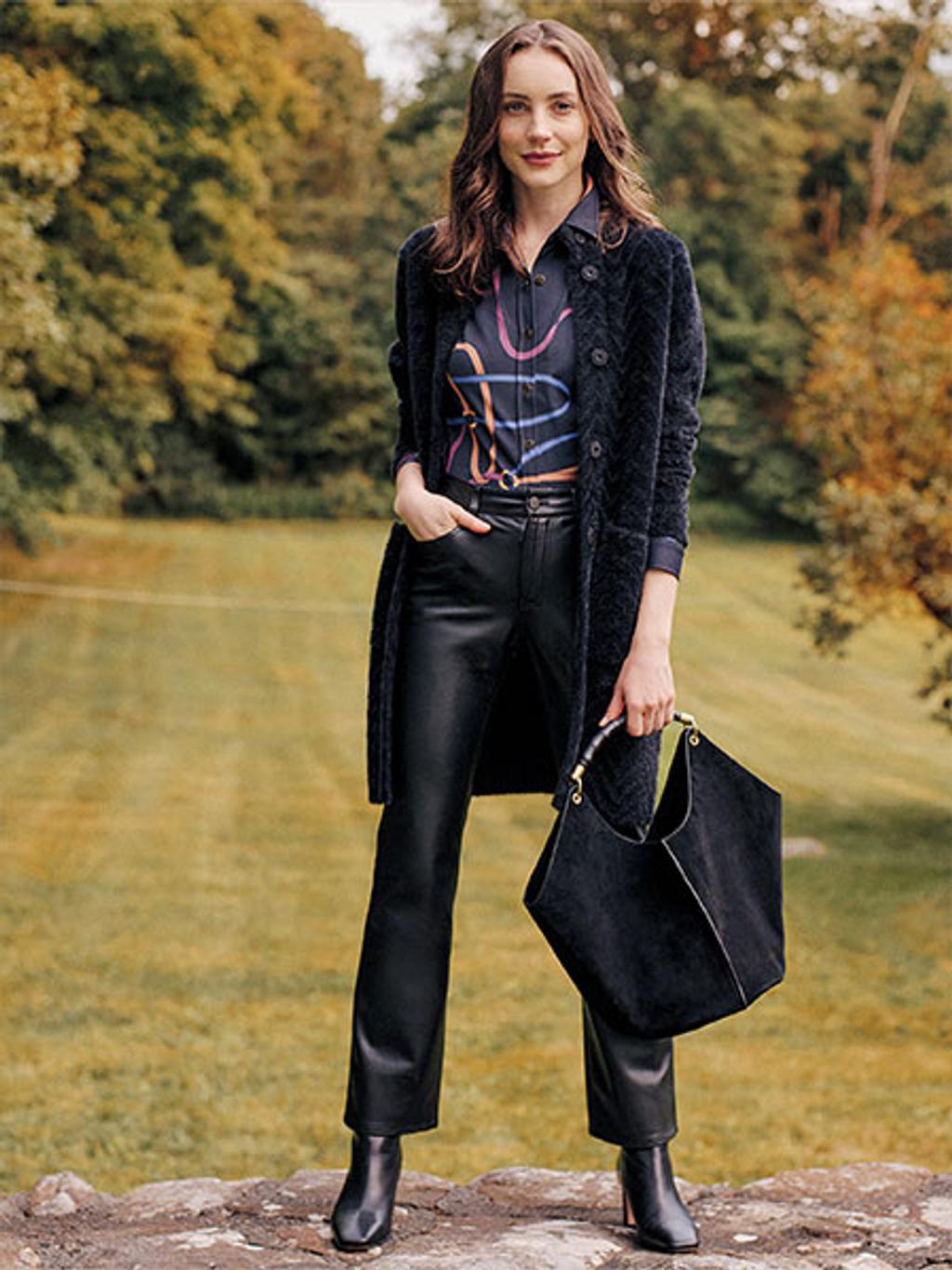 Model wearing Tripp cardi-coat, blouse, and faux-leather pants