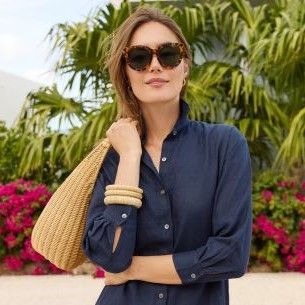 woman holding natural wicker bag over her shoulder
