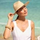 woman on beach in natural paper straw hat