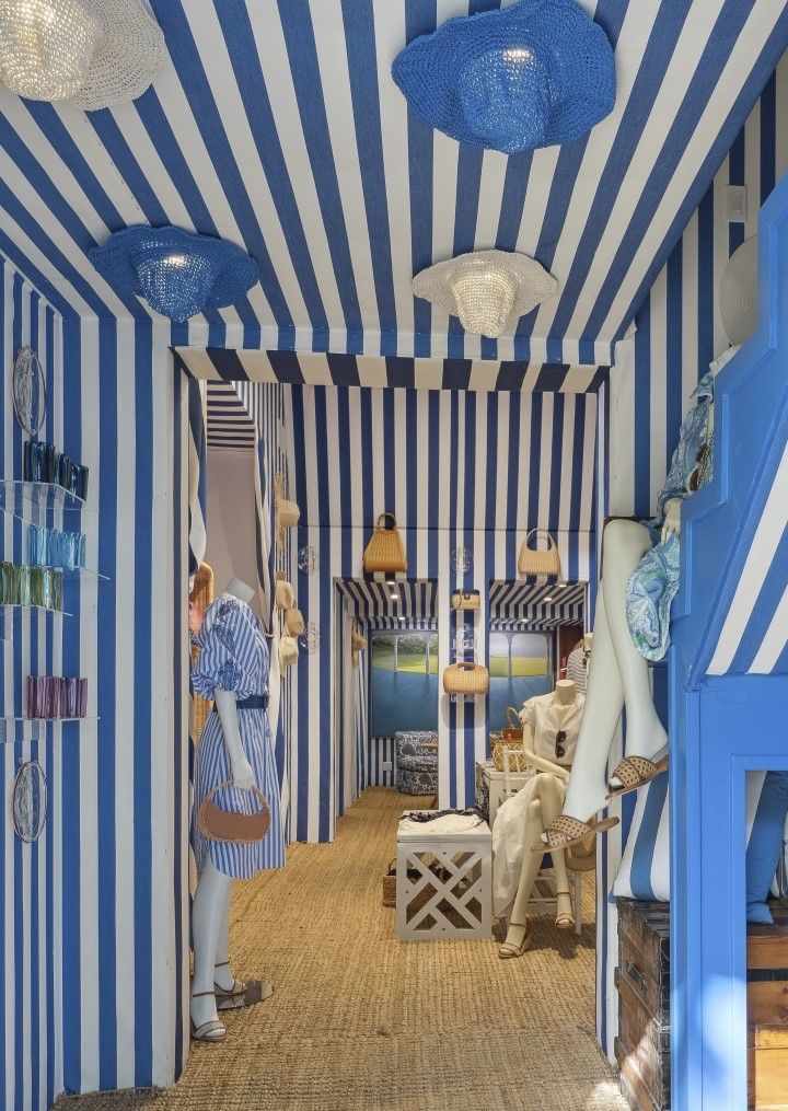 interior of womens apparel lifestyle boutique shop with blue and white cabana stripe motif