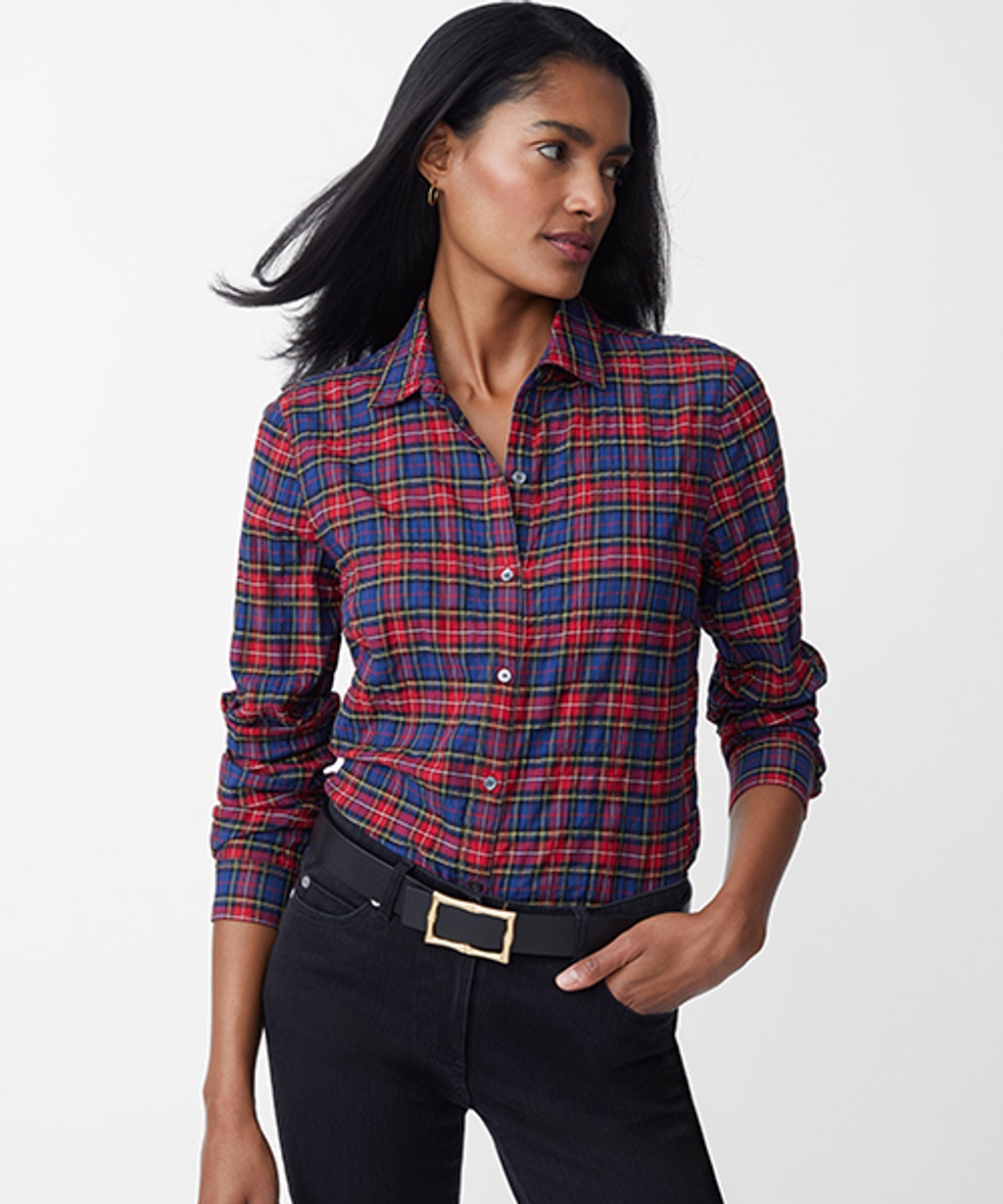 Model wearing tartan button-down, slim fit jeans, and reversible leather belt.
