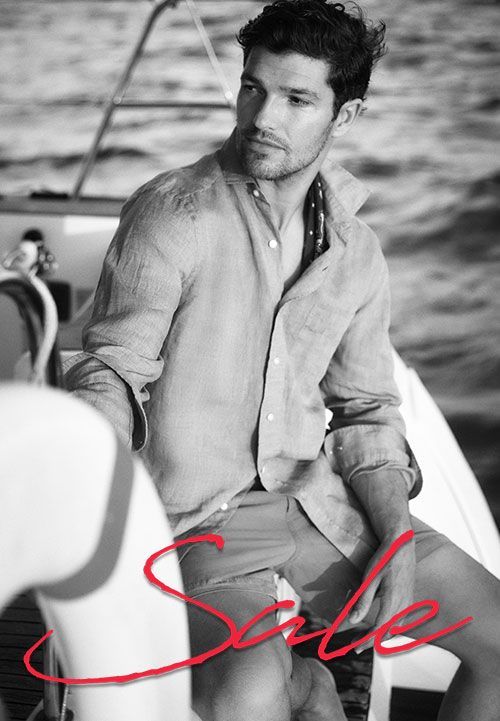 black and white image of man on a boat with red sale cursive text overlayed