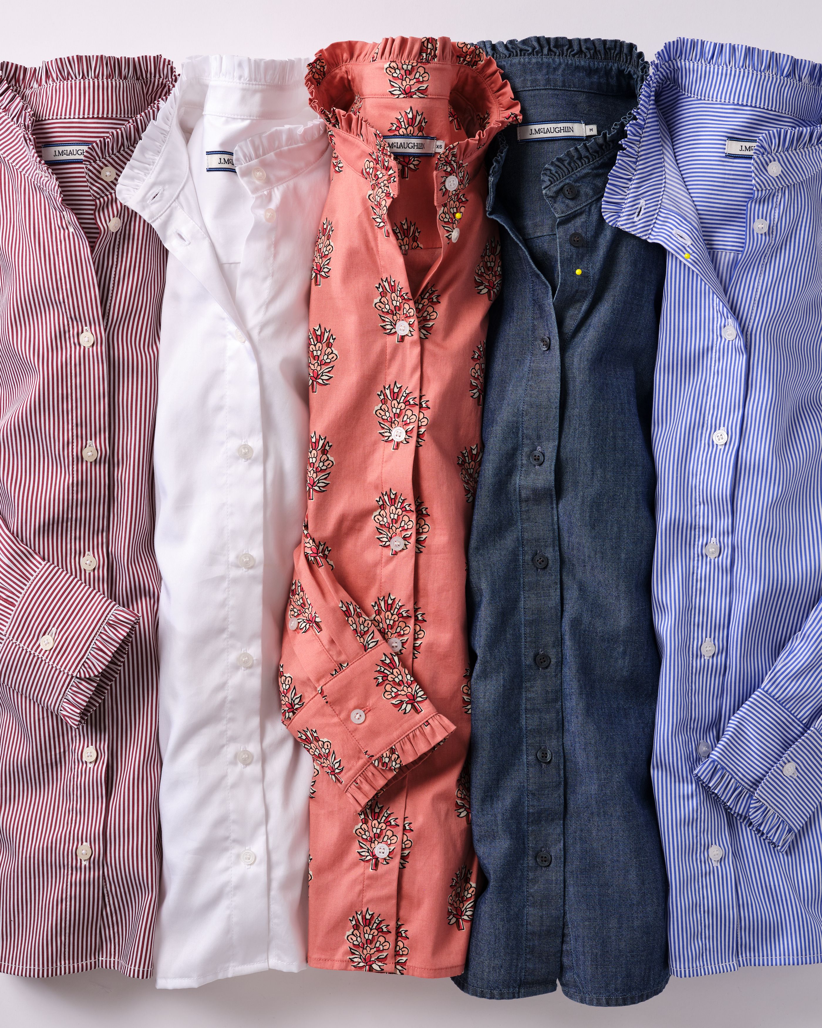 Five ruffled long-sleeve shirts: red stripe, white, coral floral, denim, and blue stripe.