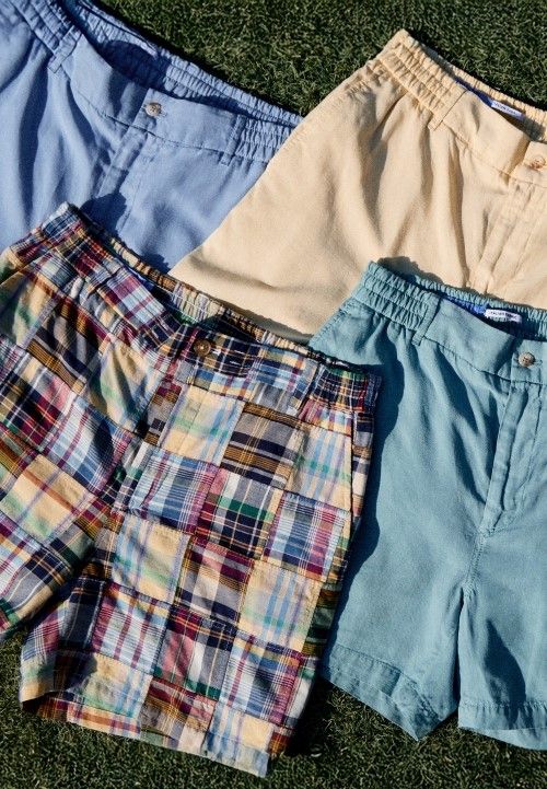 Group of mens shorts in various colors lying in a group on the grass