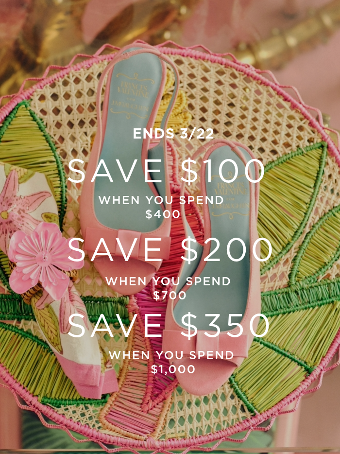 laydown of womens pink peep bow toe heels on pink and green floral pattern table