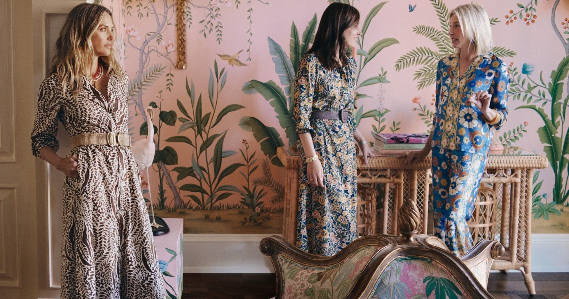 group of women in living room wearing printed dresses