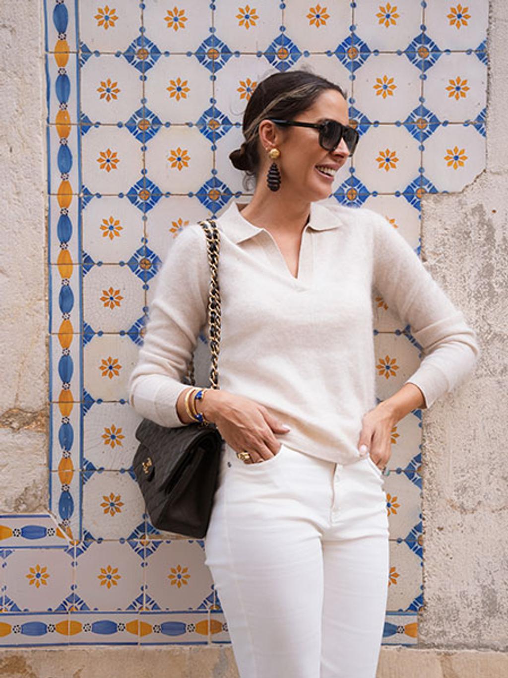 Filipa in cashmere sweater and jeans in front of tiled backdrop Filipa in cashmere sweater and jeans in front of tiled backdrop