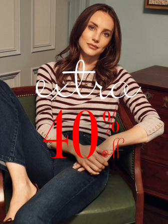 woman seated wearing beige and brown stripe sweater