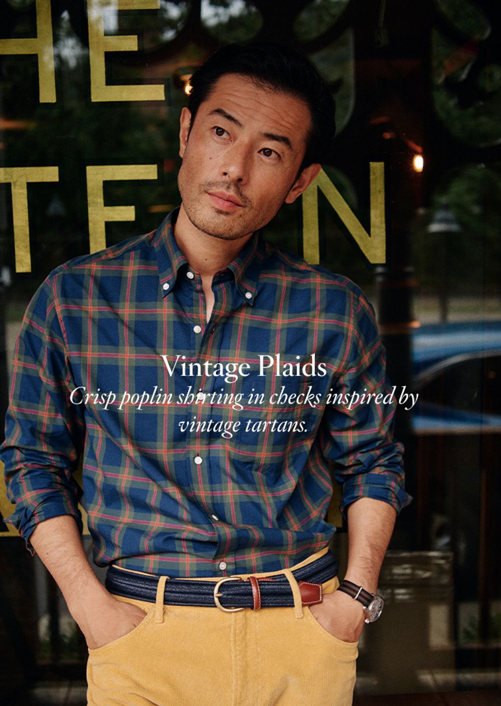 Male model wearing plaid shirt and yellow corduroy pants.