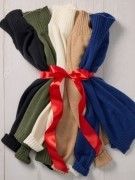 group of womens cashmere turtleneck sweaters in various colors tied together with red bow
