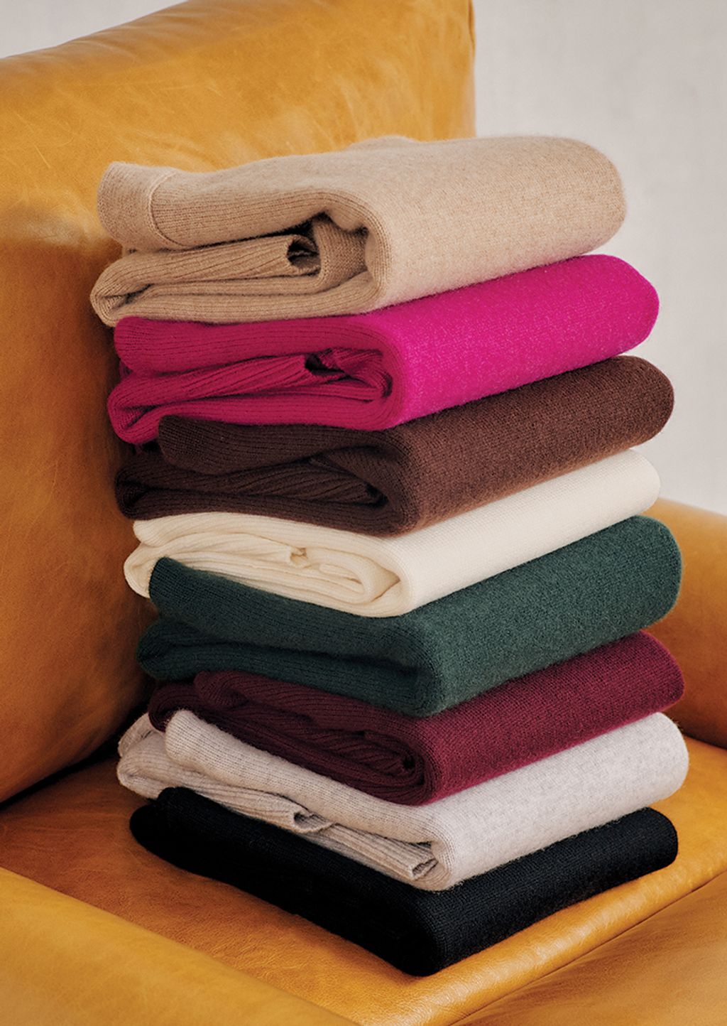 Stack of woman's cashmere Dina Turtleneck sweaters.