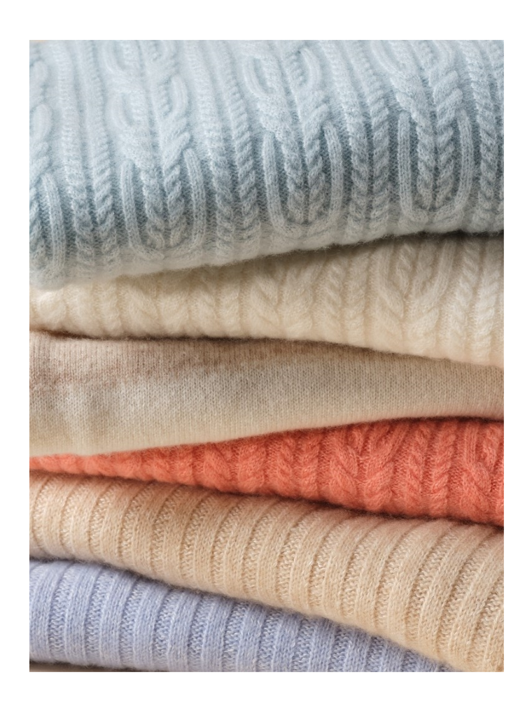 stack of soft hued cashmere sweaters in various colors with subtle texture