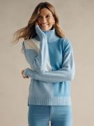 woman wearing powder blue colorblock cashmere turtleneck