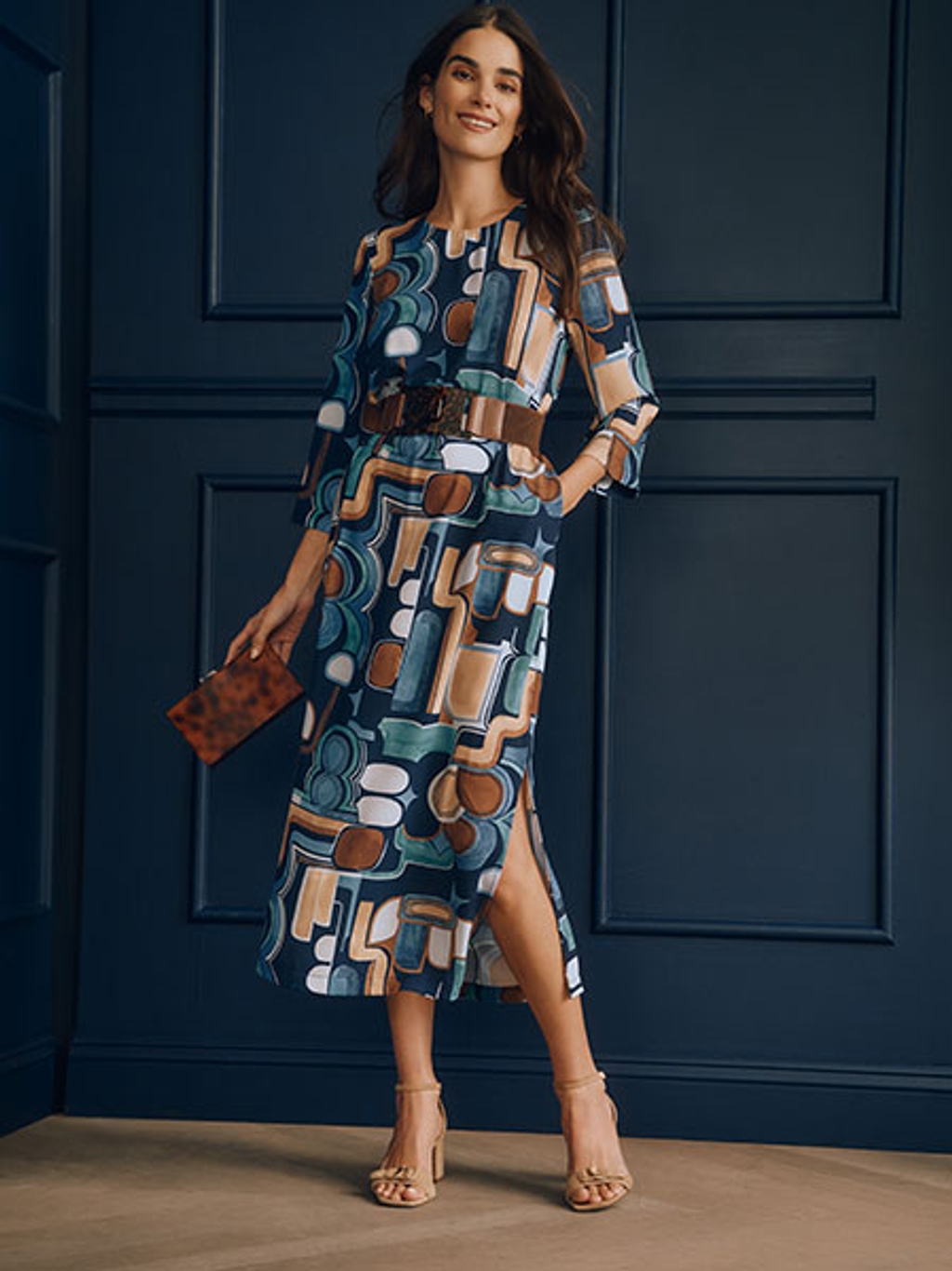 Model in printed midi dress and sandals