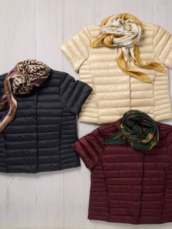 laydown of womens puffer jackets with scarves