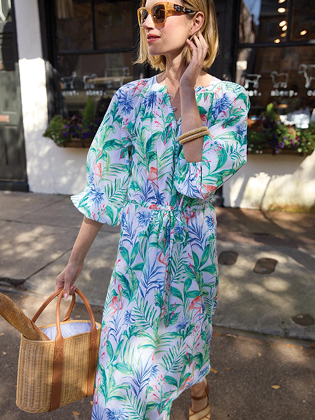 Model in tropical-print dress with wicker bag