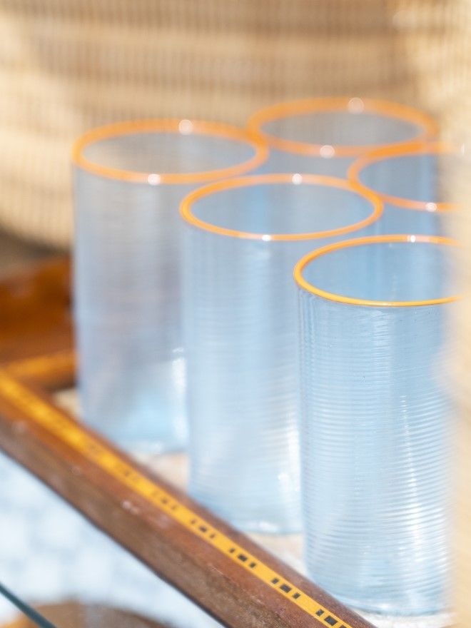 close up image of set of glasses with orange trim at top