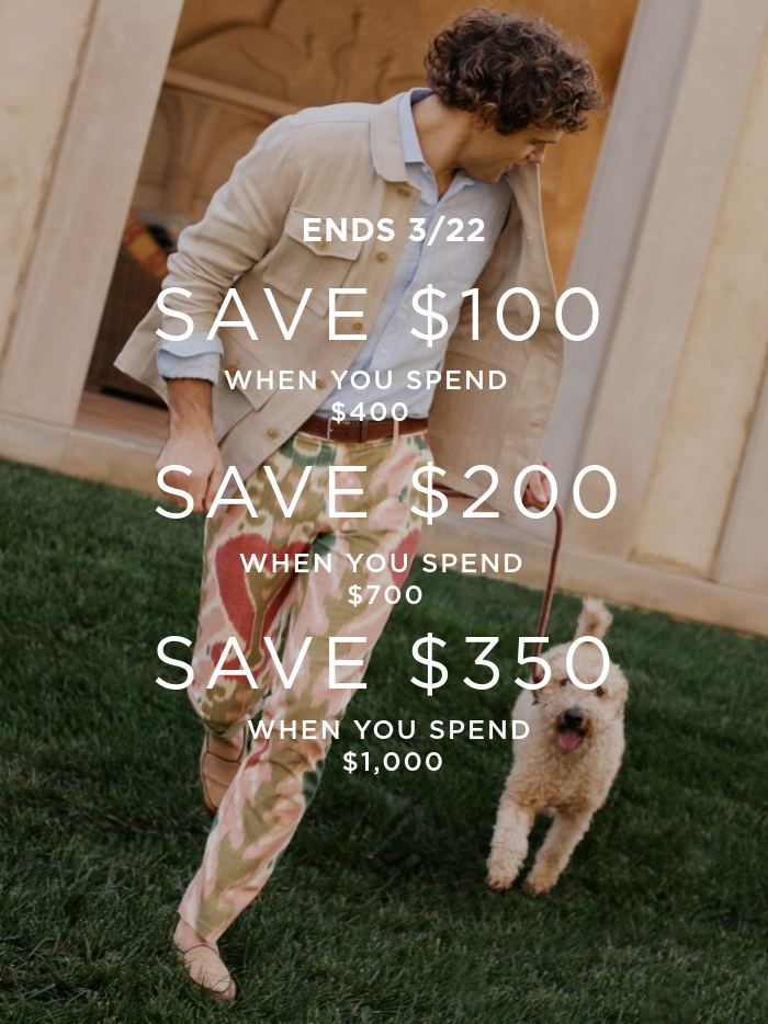 man running outside with dog wearing paisley multicolor printed pants