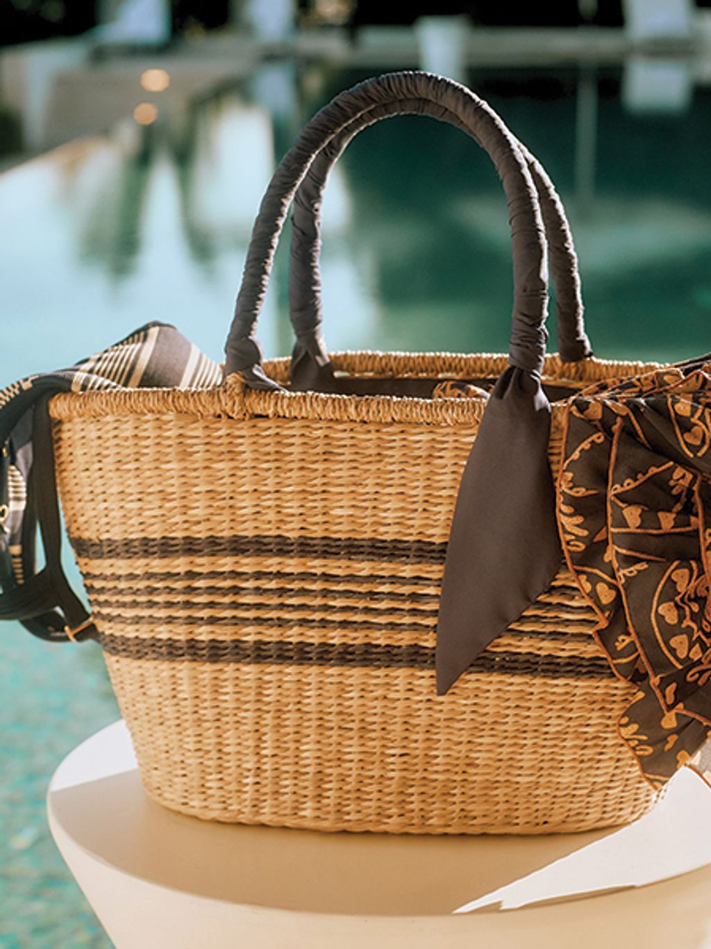 Striped straw bag by pool