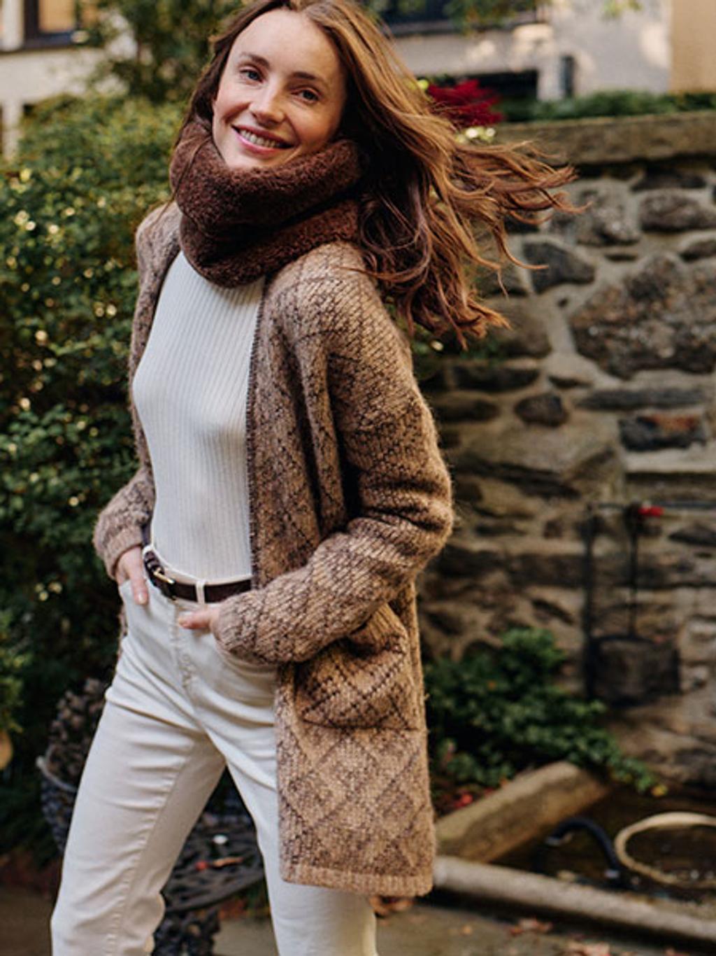 Model wearing long cardigan, turtleneck, and off-white jeans with snood outside Model wearing long cardigan, turtleneck, and off-white jeans with snood outside