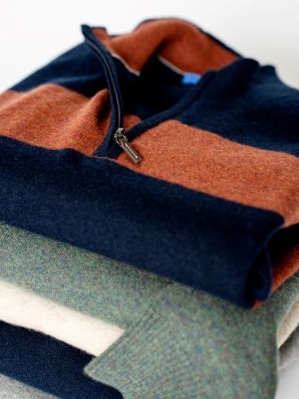 stack of mens cashmere 1/4 zip sweaters in various colors