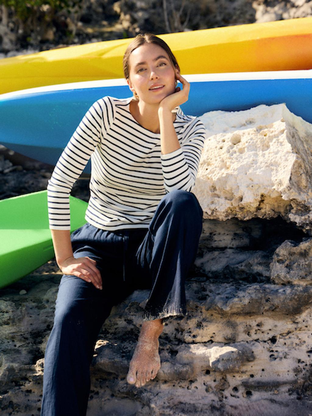 Woman in striped shirt and navy pants