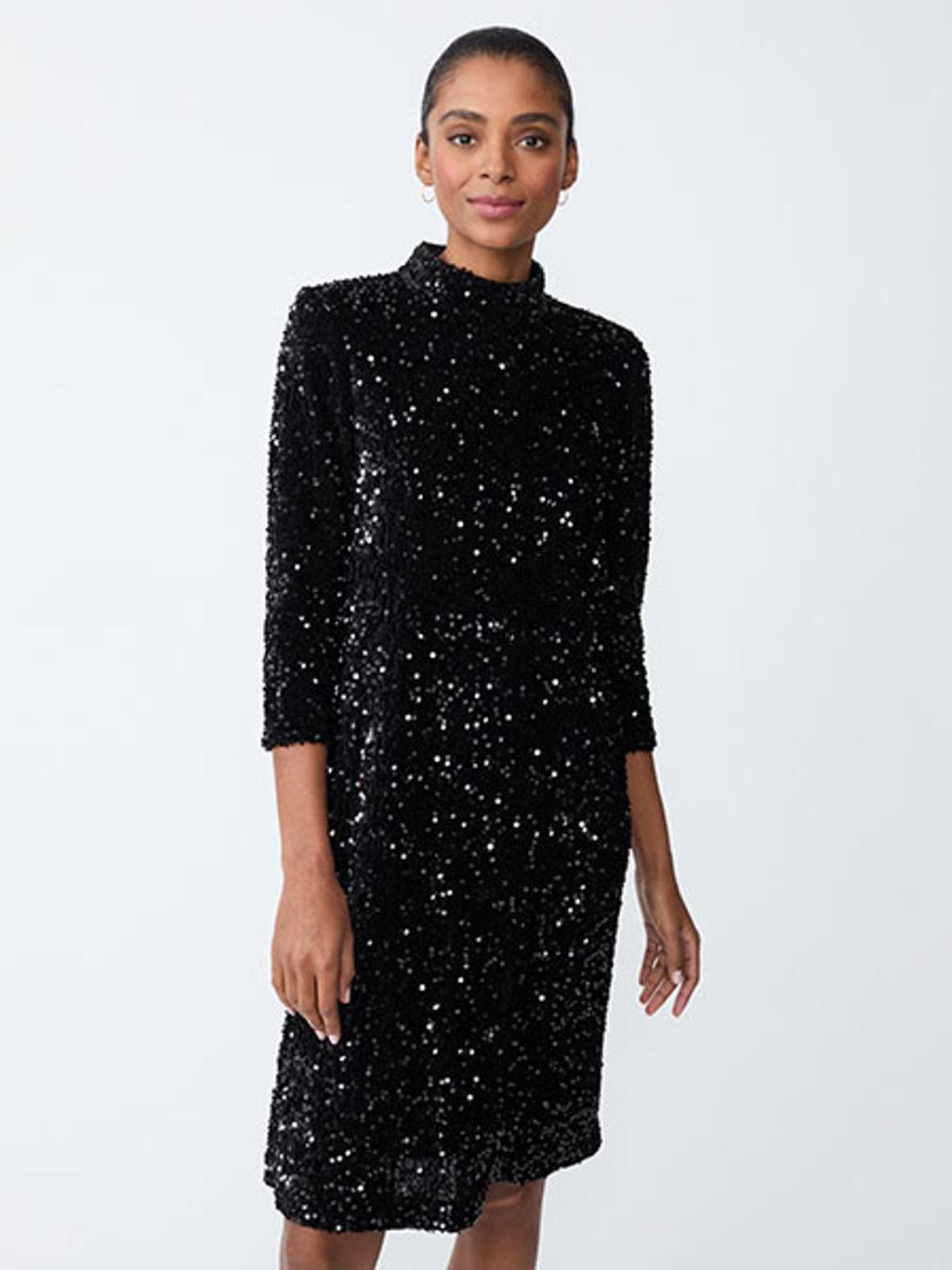 Model wearing black sequined dress Model wearing black sequined dress