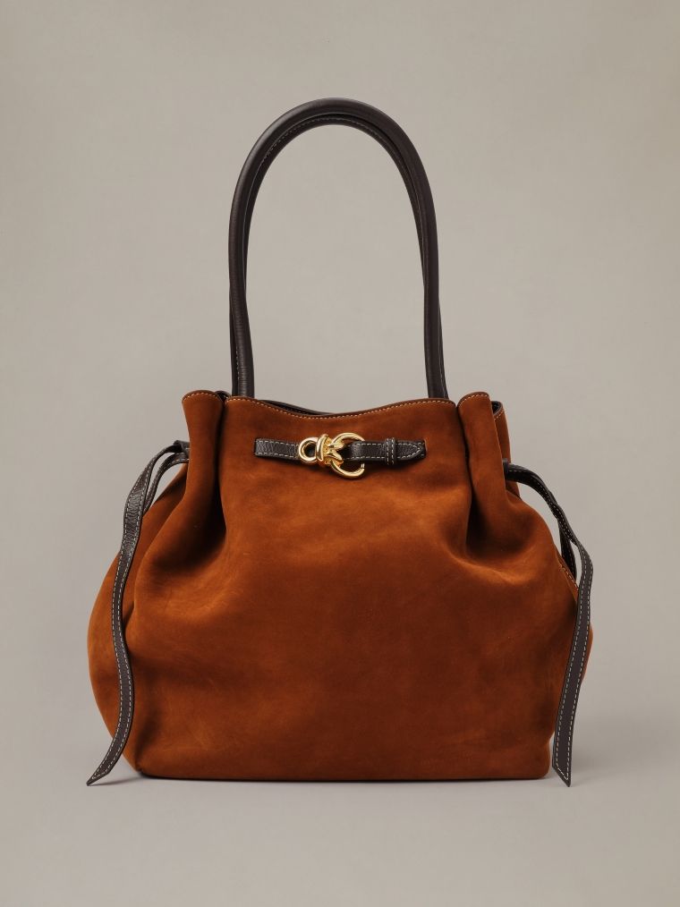 Rust suede handbag with dark brown leather handles and a gold-tone clasp.