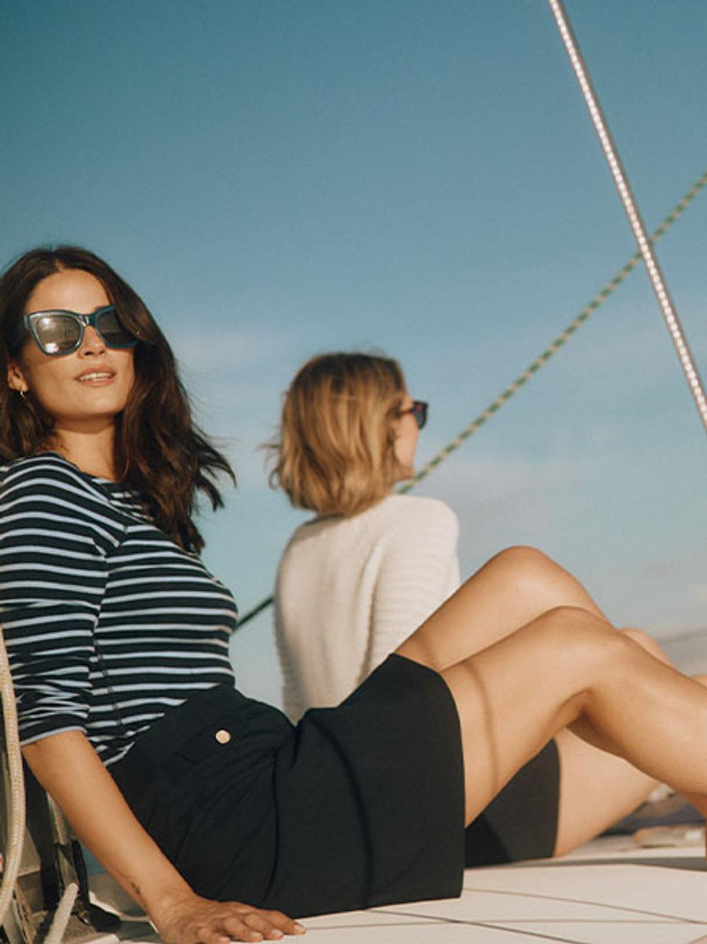 Model in striped shirt on boat