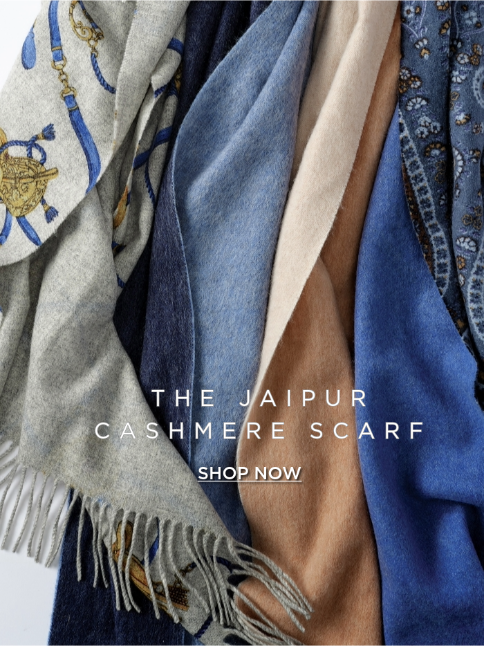 close up image of cashmere scarves in various colors with tassle trim