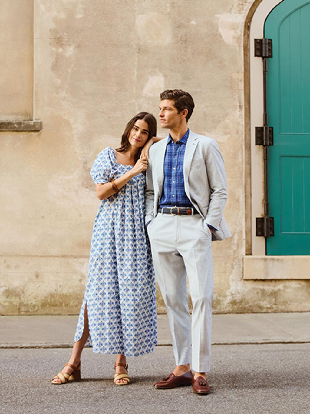 Female model in maxi dress, male model in seersucker suit, standing on street in Charleston