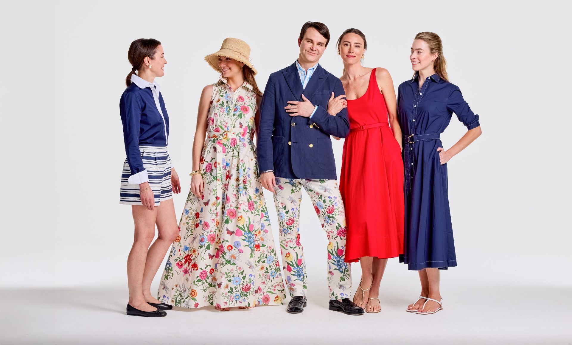 Five people pose in stylish, colorful spring outfits featuring floral patterns, stripes, and solid colors.