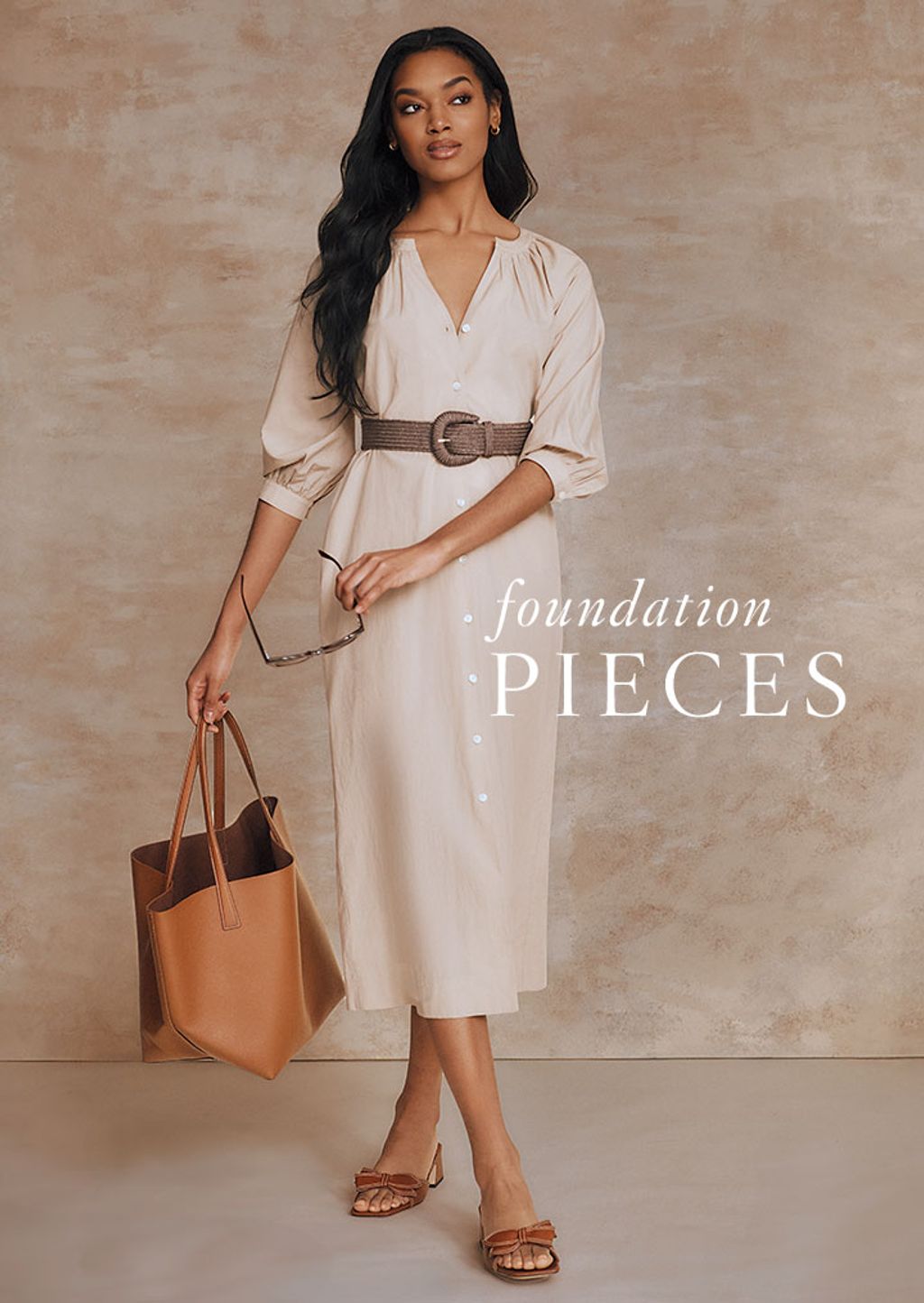 Woman wearing a 3/4 sleeve blue floral belted dress with Raffia flats.