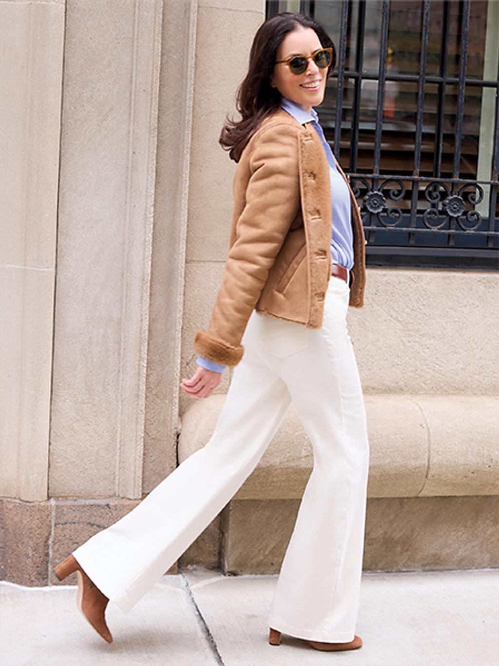 Ann Caruso in faux suede jacket, shirt, and white jeans