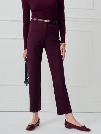 woman wearing burgundy cropped trousers with burgundy ballet flats and belt