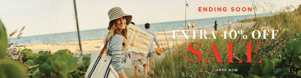 A woman in a striped hat and tote bag smiles on a beach path with ocean in background. Text: EXTRA 40% OFF SALE ENDING SOON.