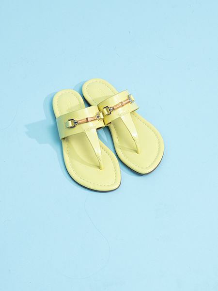 Nora Patent Leather Sandals in Chartreuse on a light blue background