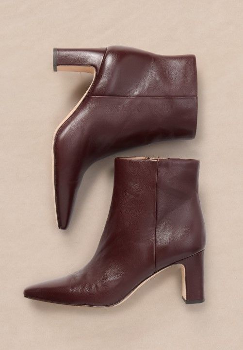womens merlot leather ankle boots on light brown studio background