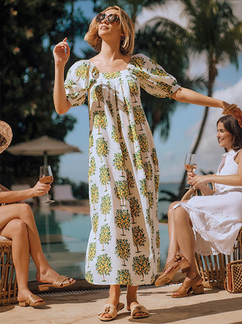 Model in lemon puff-sleeve maxi dress by pool