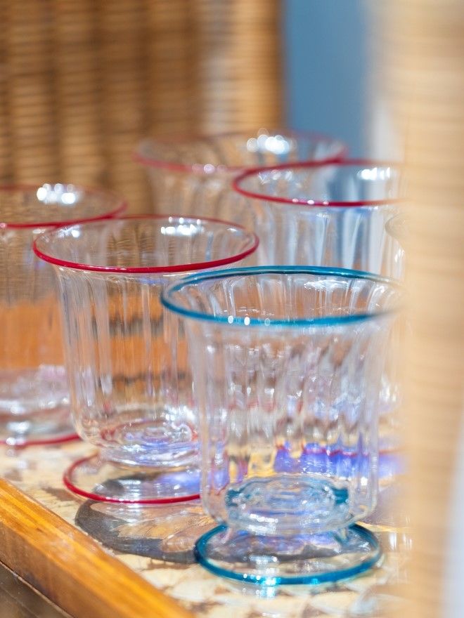 close up image of a set of glasses with either purple or blue trim at base and at top