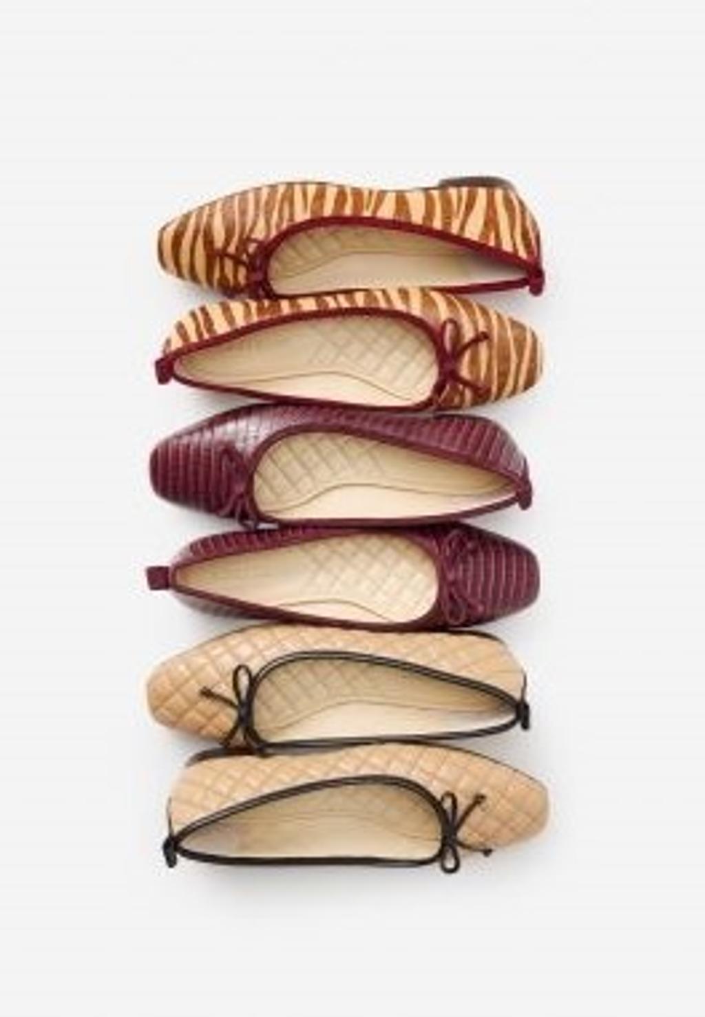 Row of various styles of ballet flats.