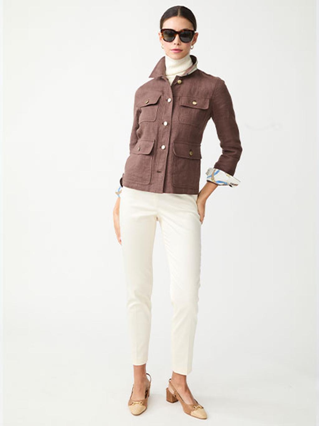 Model in brown jacket, ivory sweater, and ivory pants Model in brown jacket, ivory sweater, and ivory pants