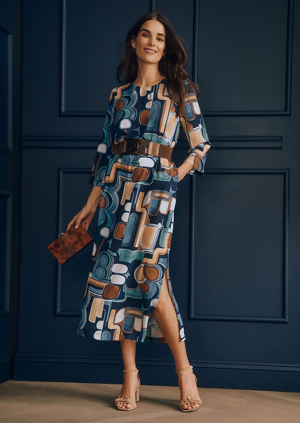 Model wearing printed midi dress with clutch and heels Model wearing printed midi dress with clutch and heels