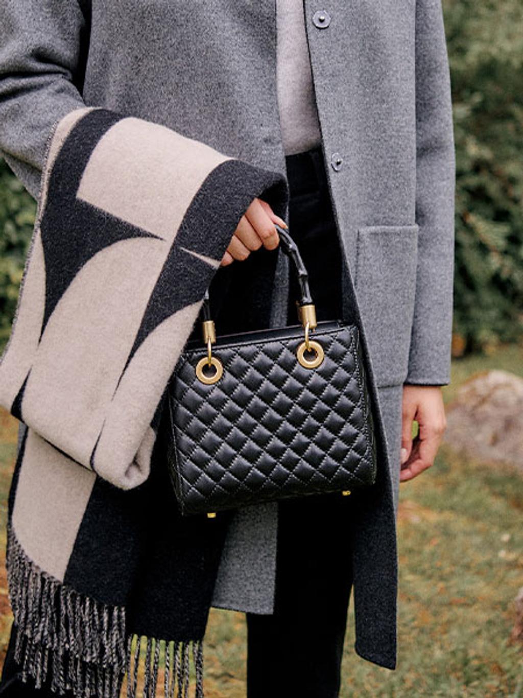 Model carrying structured quilted top-handle bag