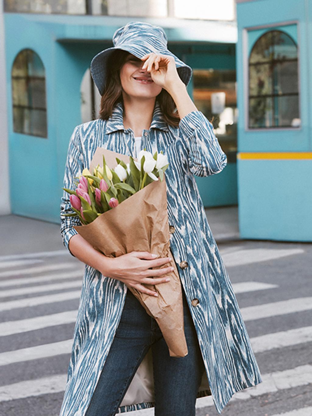 Model wearing marbled blue coat.