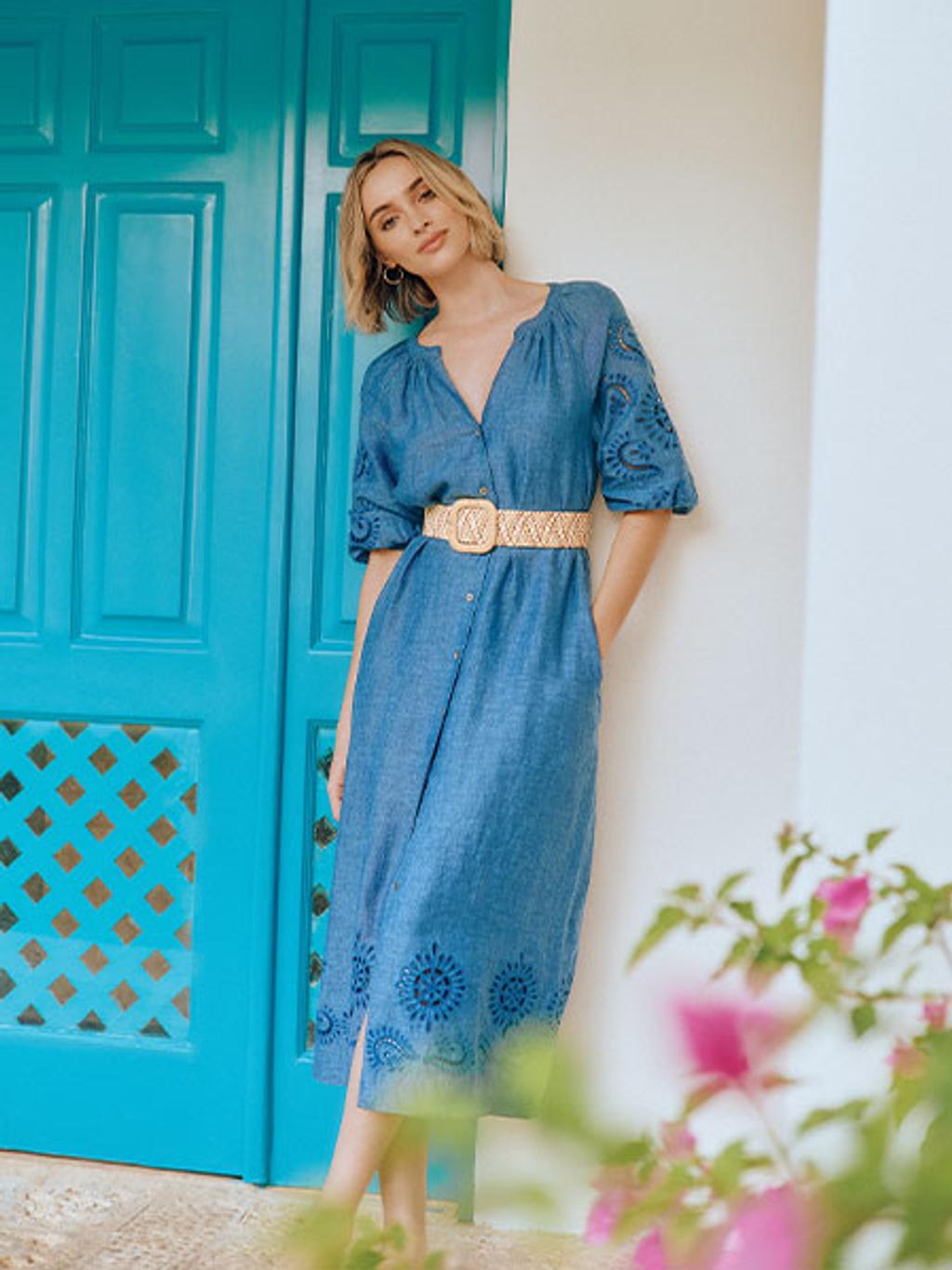 Model in blue embroidered linen dress